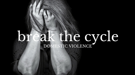 blog graphic featuring a woman clutching her head in her hands in black and white text says 'break the cycle domestic violence'