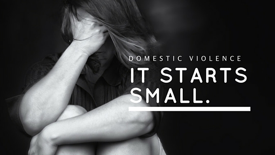 woman siting with her arms around her knees and face in black and white text says 'domestic violence it starts small'