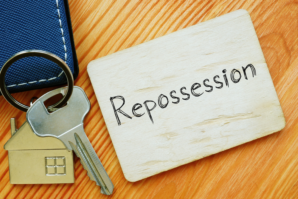 A house key with the word Repossession next to it. 